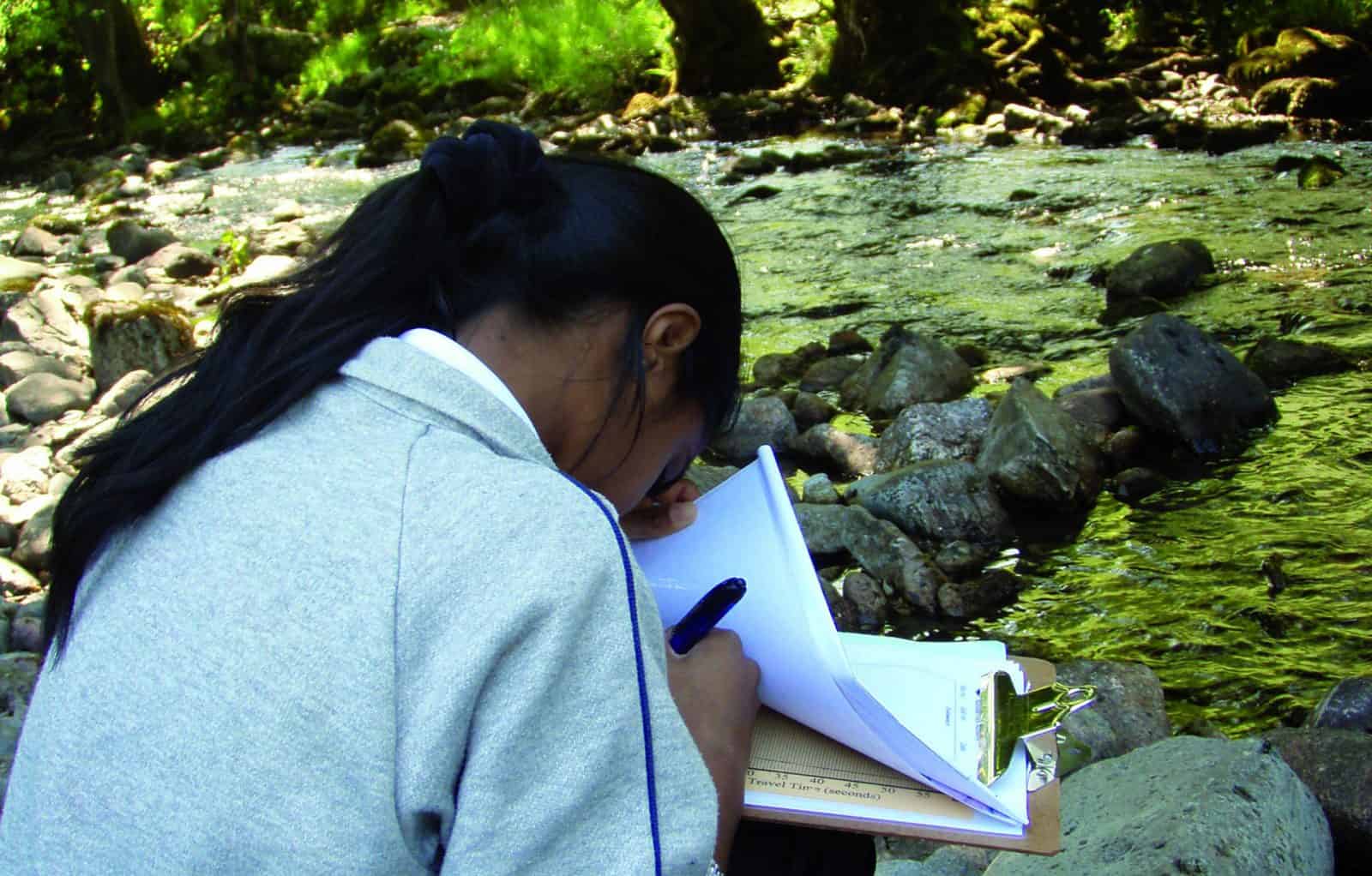key stage 3 girl working by a river