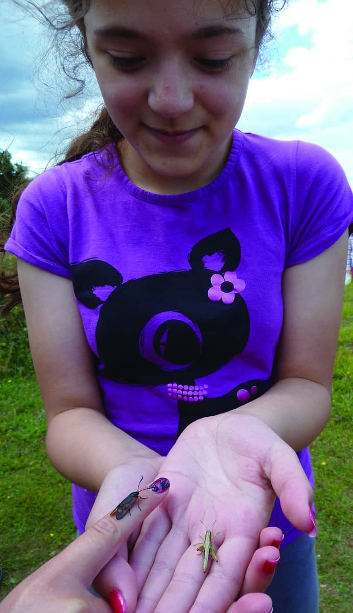 girl holding insect