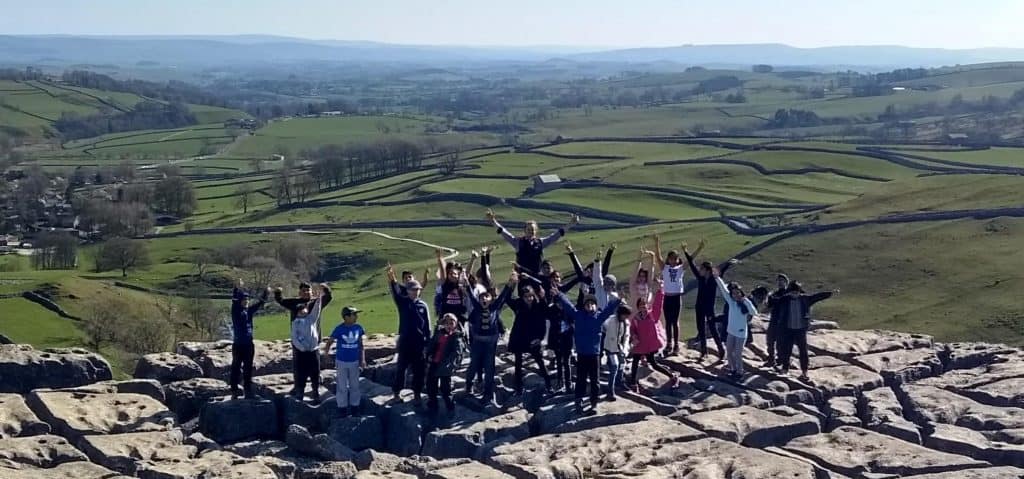 A group of children celebrating outdoors