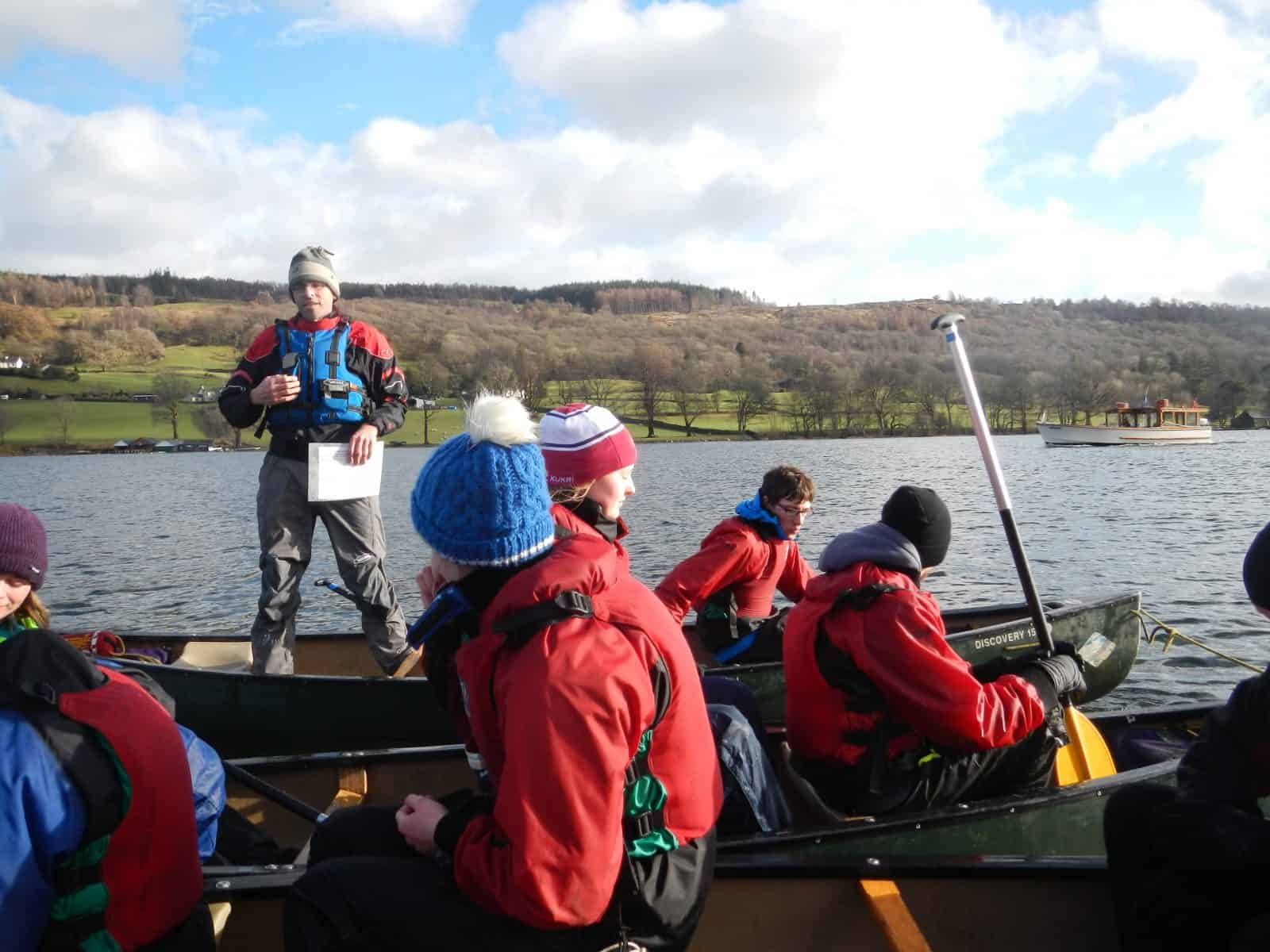 Tutor teaching Geography form a canoe at Castle Head