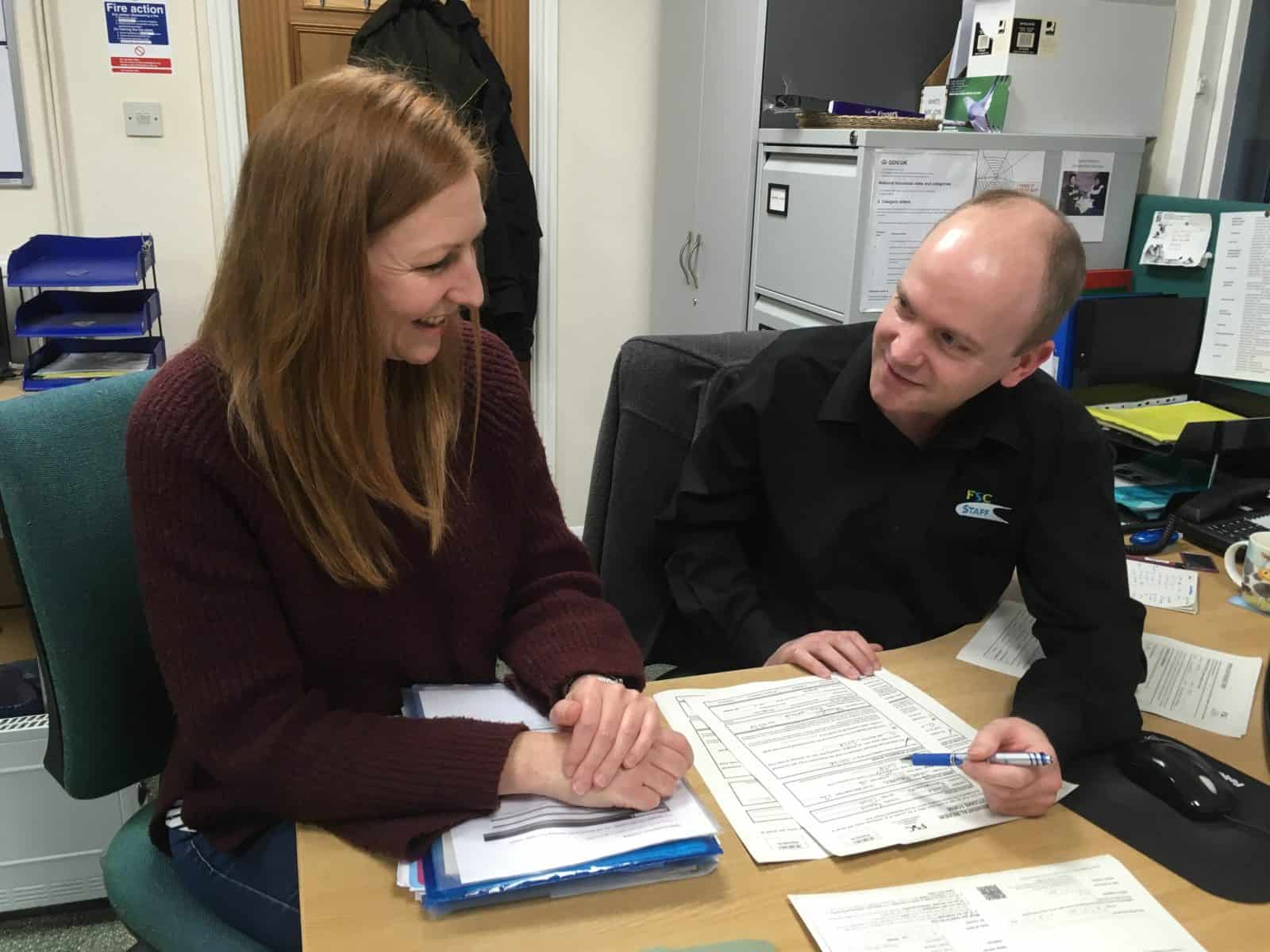 two members of staff working together