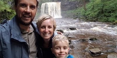 Family selfie in front of a waterfall