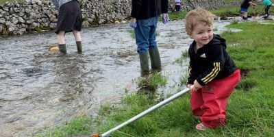 A little child river dipping