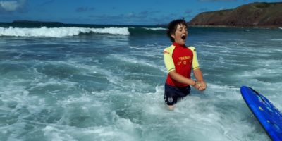 A boy body boarding near Dale Fort