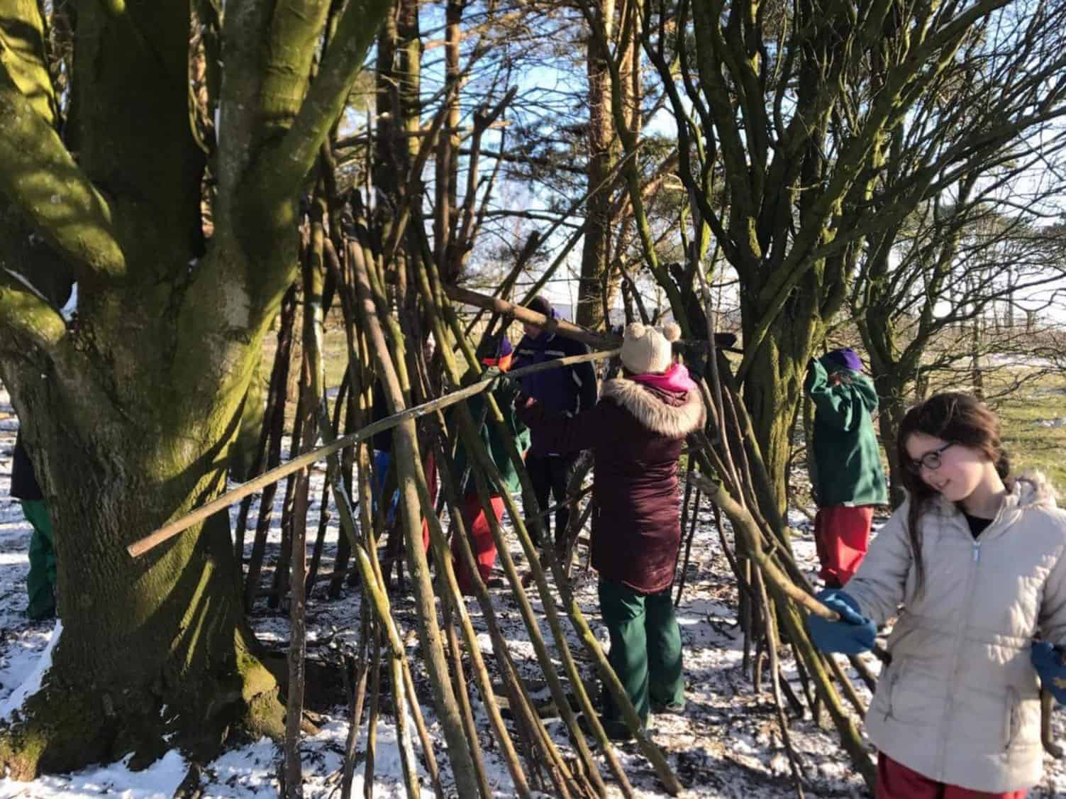 Kids Fund Primary School Children Making Dens in Snow