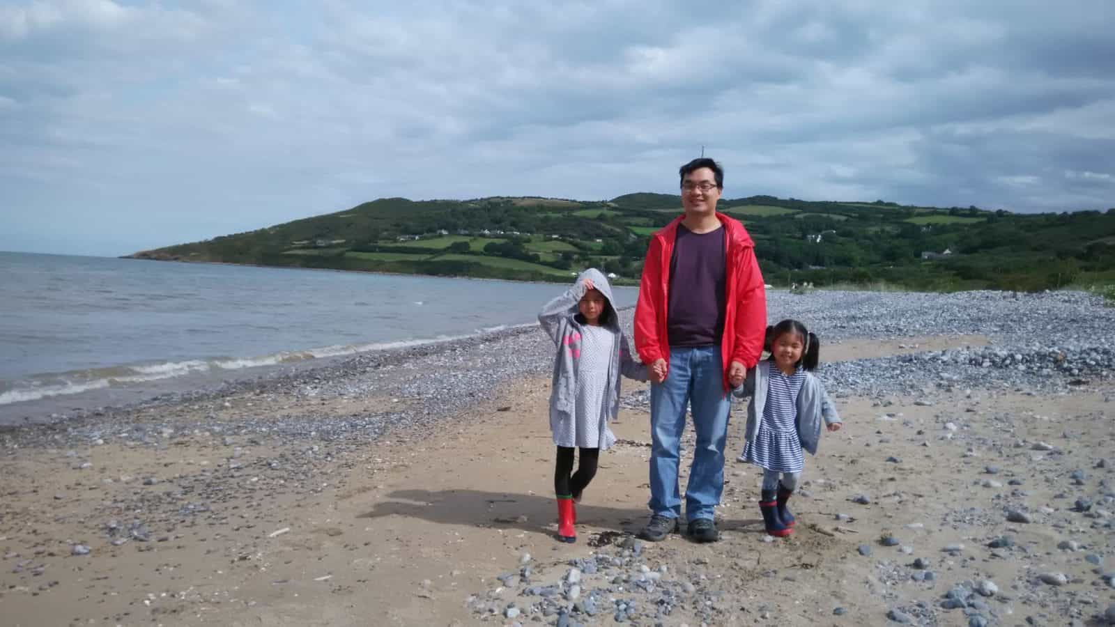 A family walking along the beach in Snowdonia