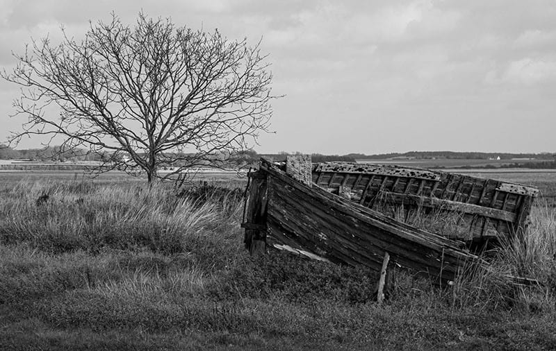 An abandoned boat on the salt marsh © Peter Derby