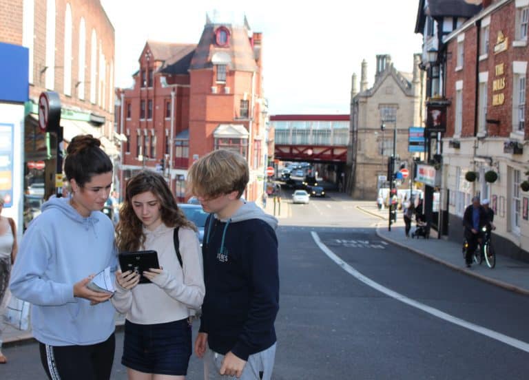 Three students in an urban area