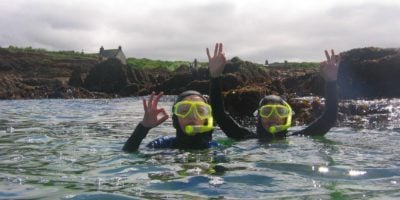Two yound people snorkelling