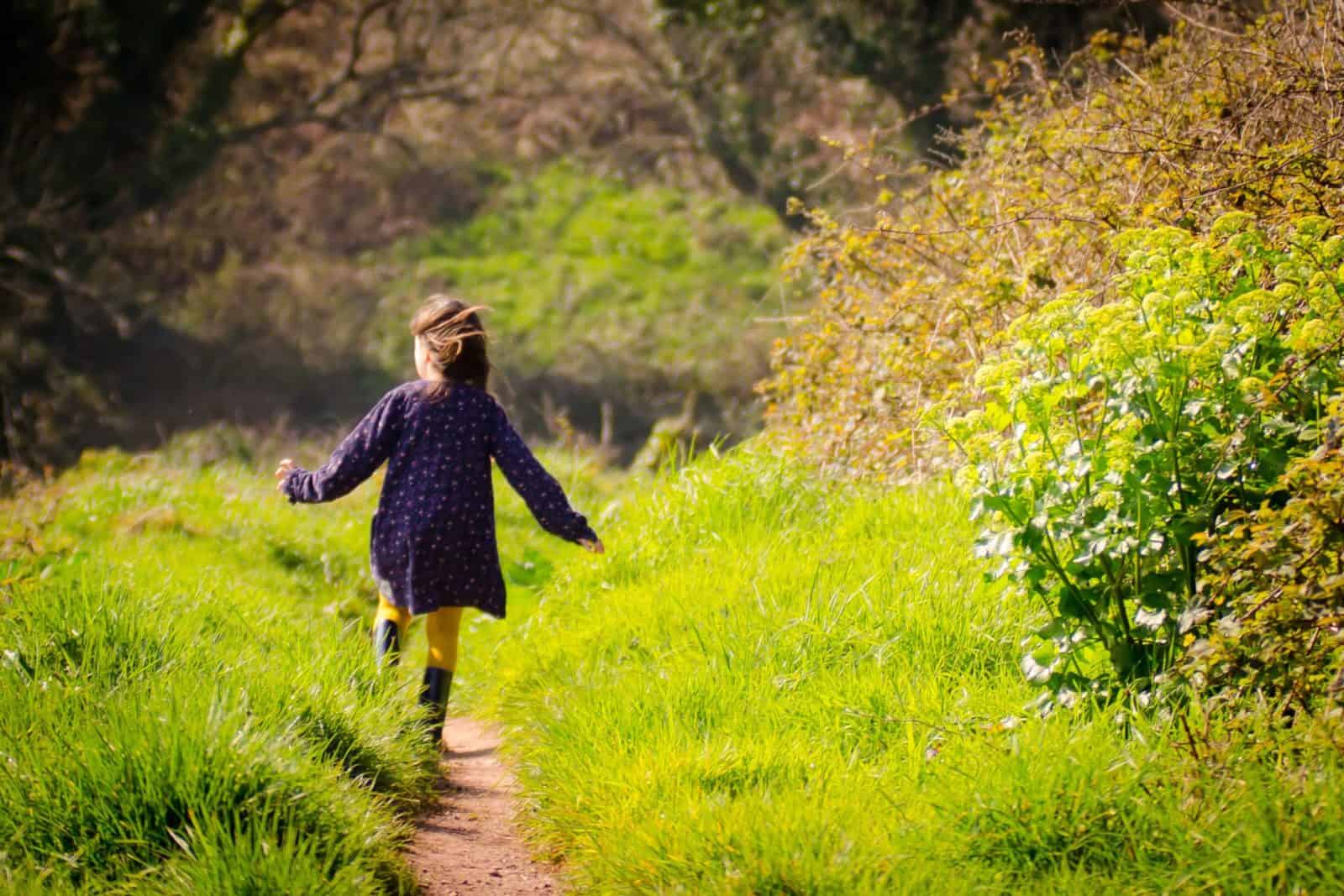 Girl skipping in to woods