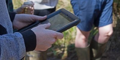 student using a tablet in the outdoors