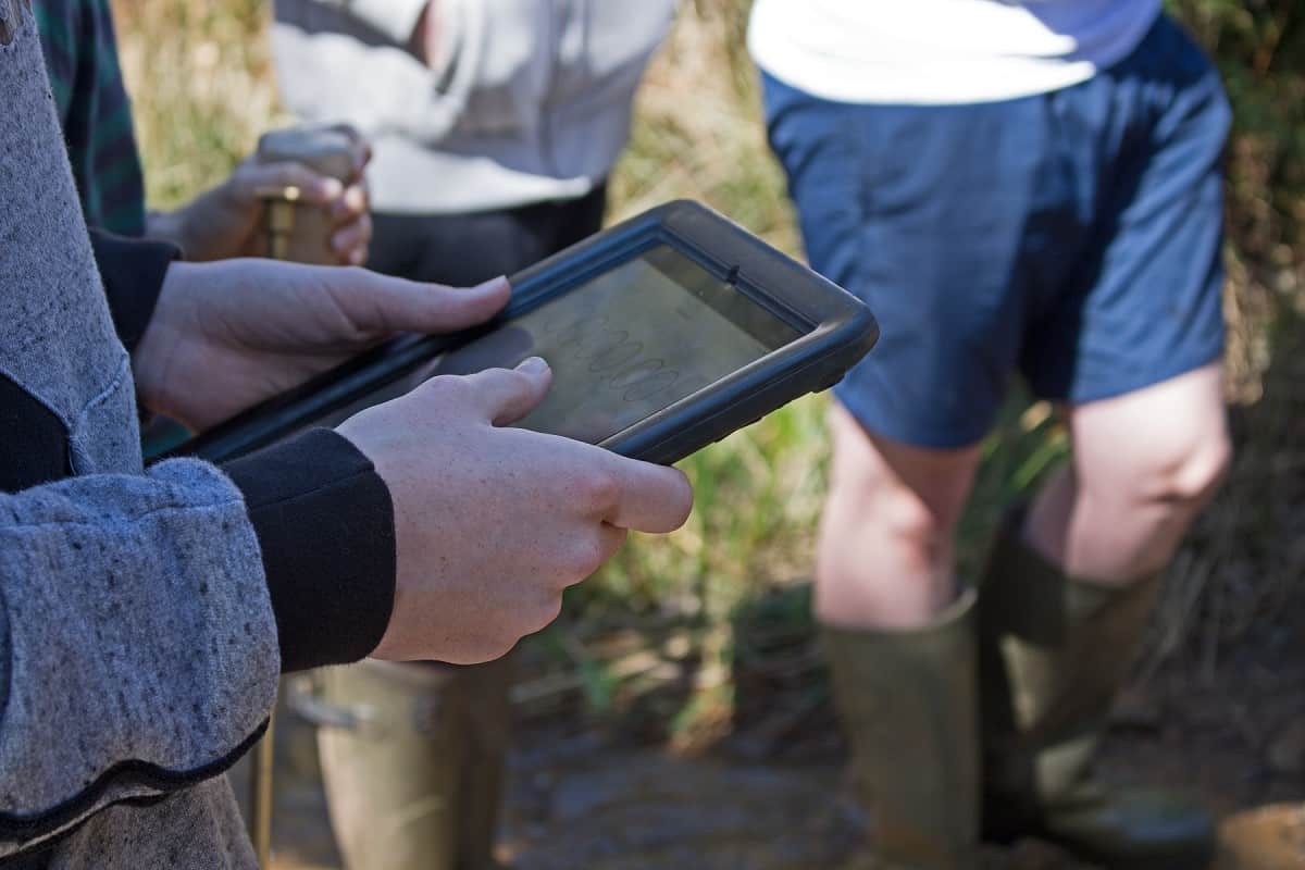 student using a tablet in the outdoors