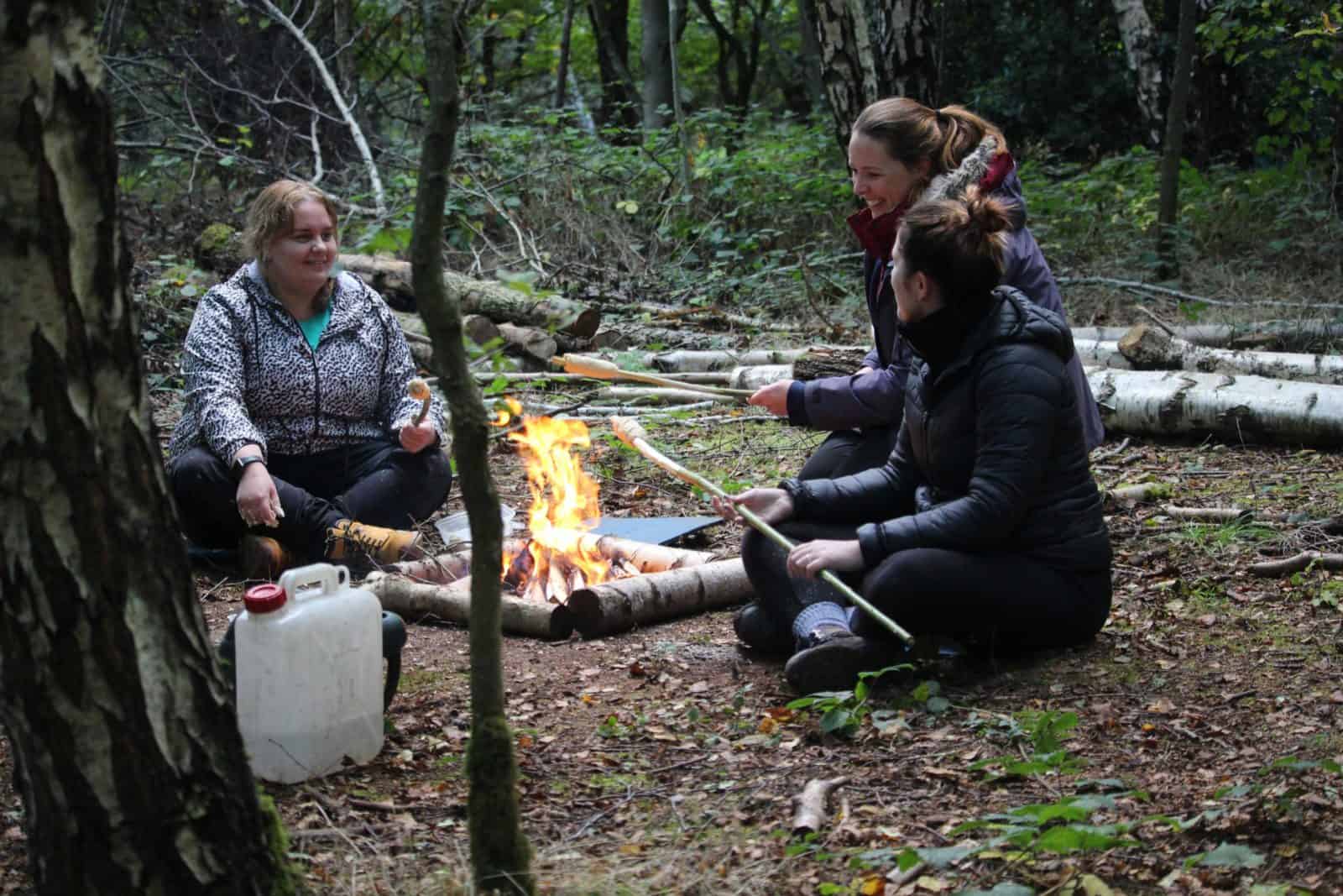 Teachers cooking bread on a campfire