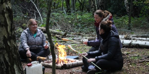 Teachers cooking bread on a campfire