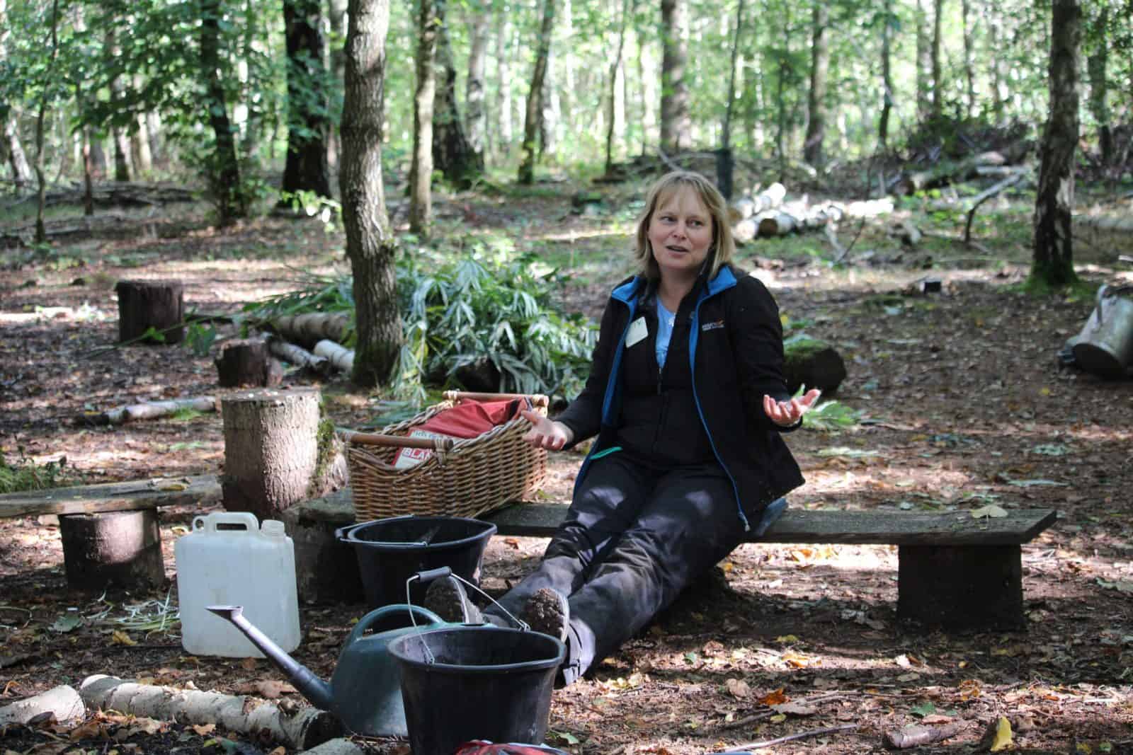 A tutor sat on a log talking