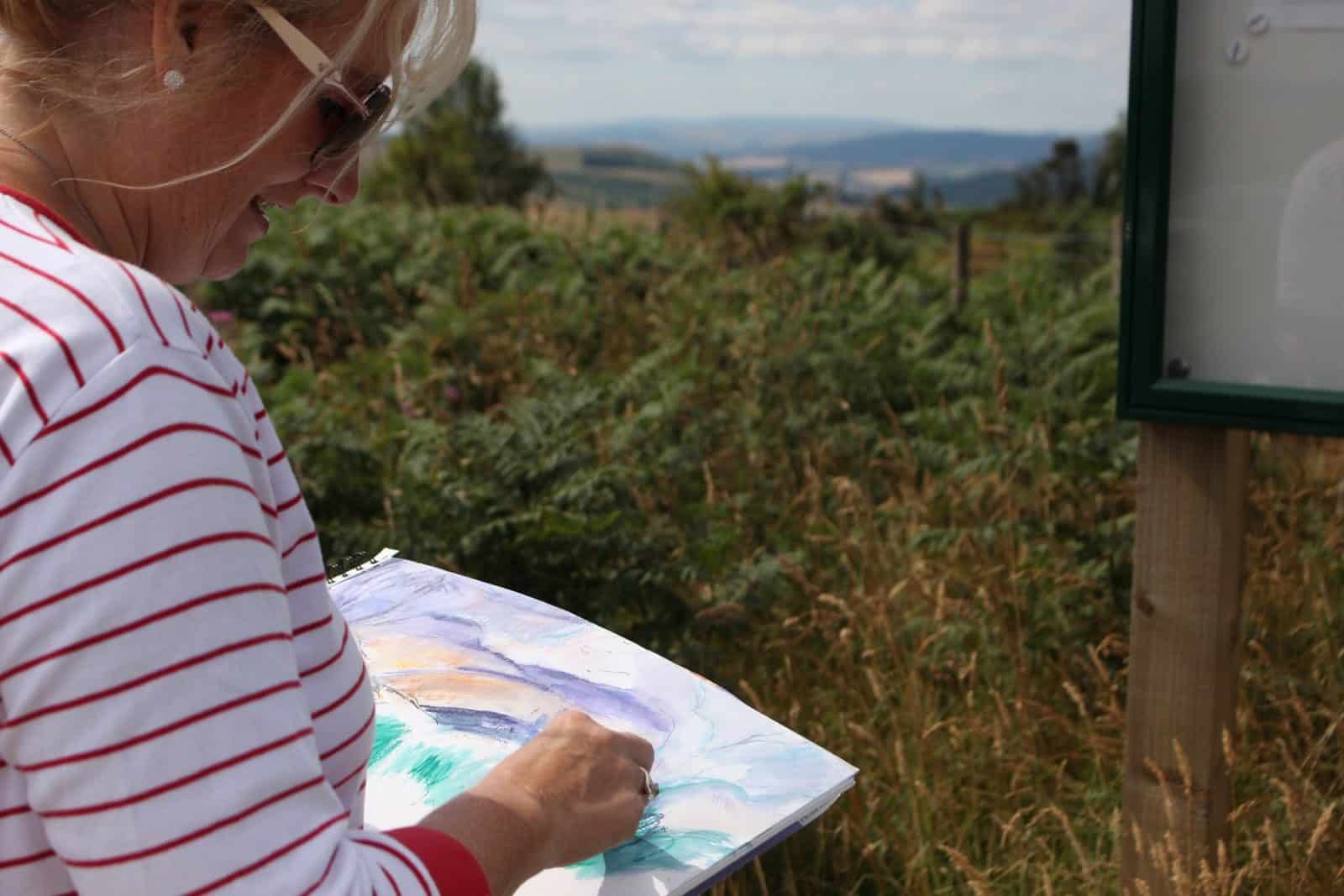 Lady sketching in the countryside