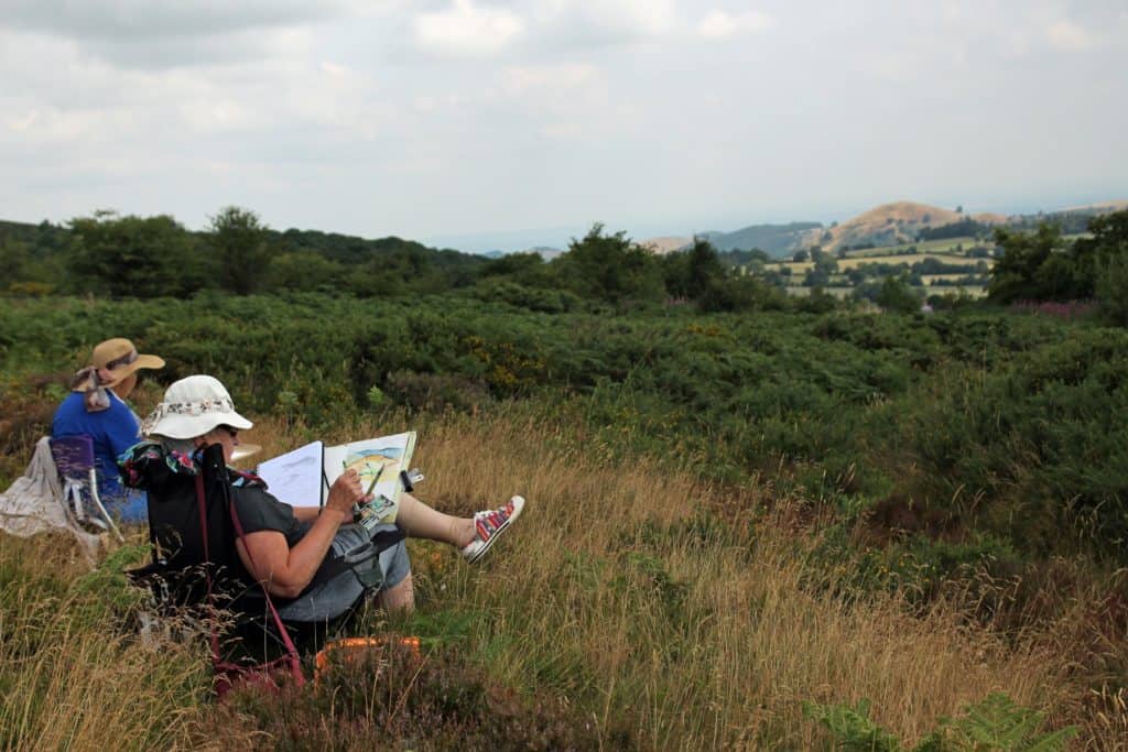 Ladies sketching in the countryside on a drawing and sketching course.