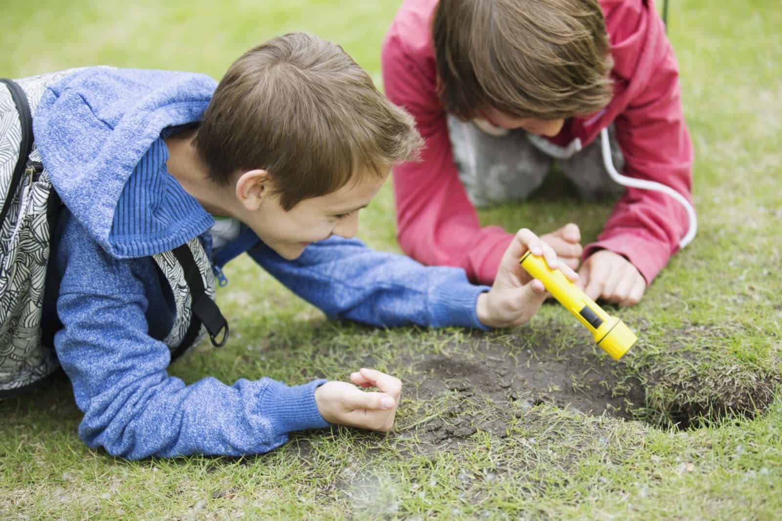 Children looking in ground