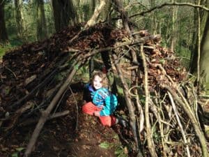 Girl in a den in the woods
