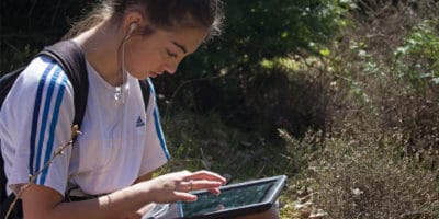 Girl using ipad in nature