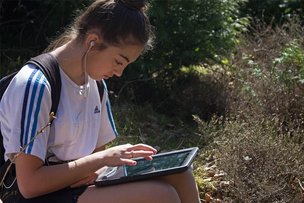 Girl using ipad in nature