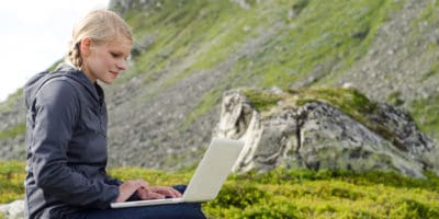 Lady with laptop in mountainous area