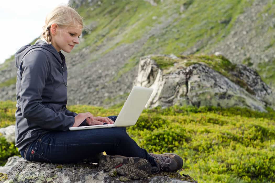 Lady with laptop in mountainous area