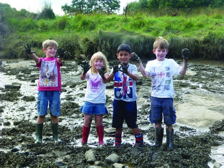 children in mud and wellies