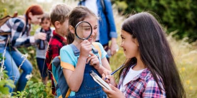 primary school children with magnifying glass