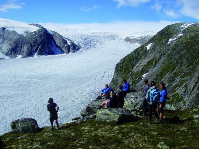 Students sitting on rocks looking at the impressive view