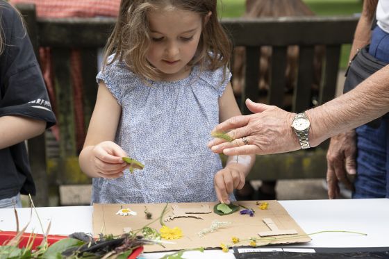 Gril making art from natural outdoor items