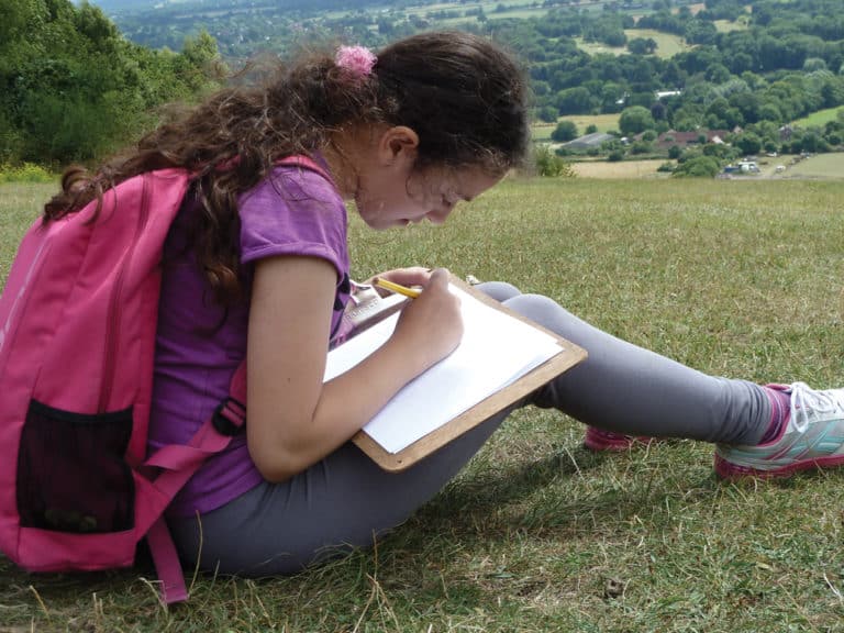 primary pupil sketching in the outdoors
