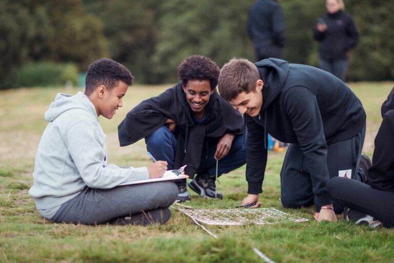 a group of boys studying a transect