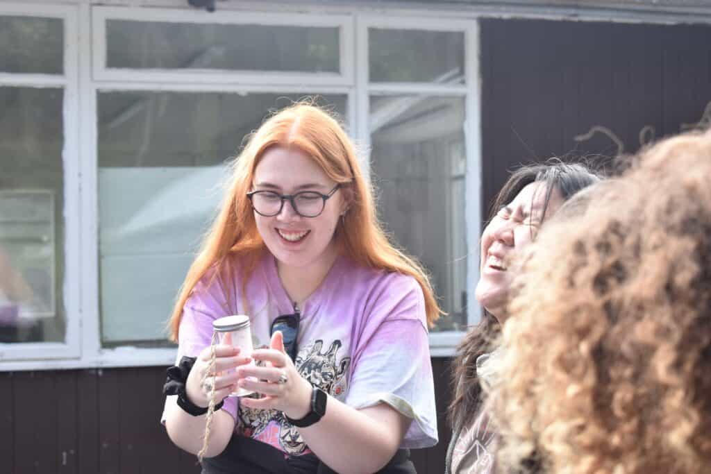 smiling girl looking at a moth