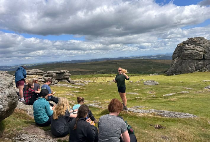 A photograph of a group of people on a hill