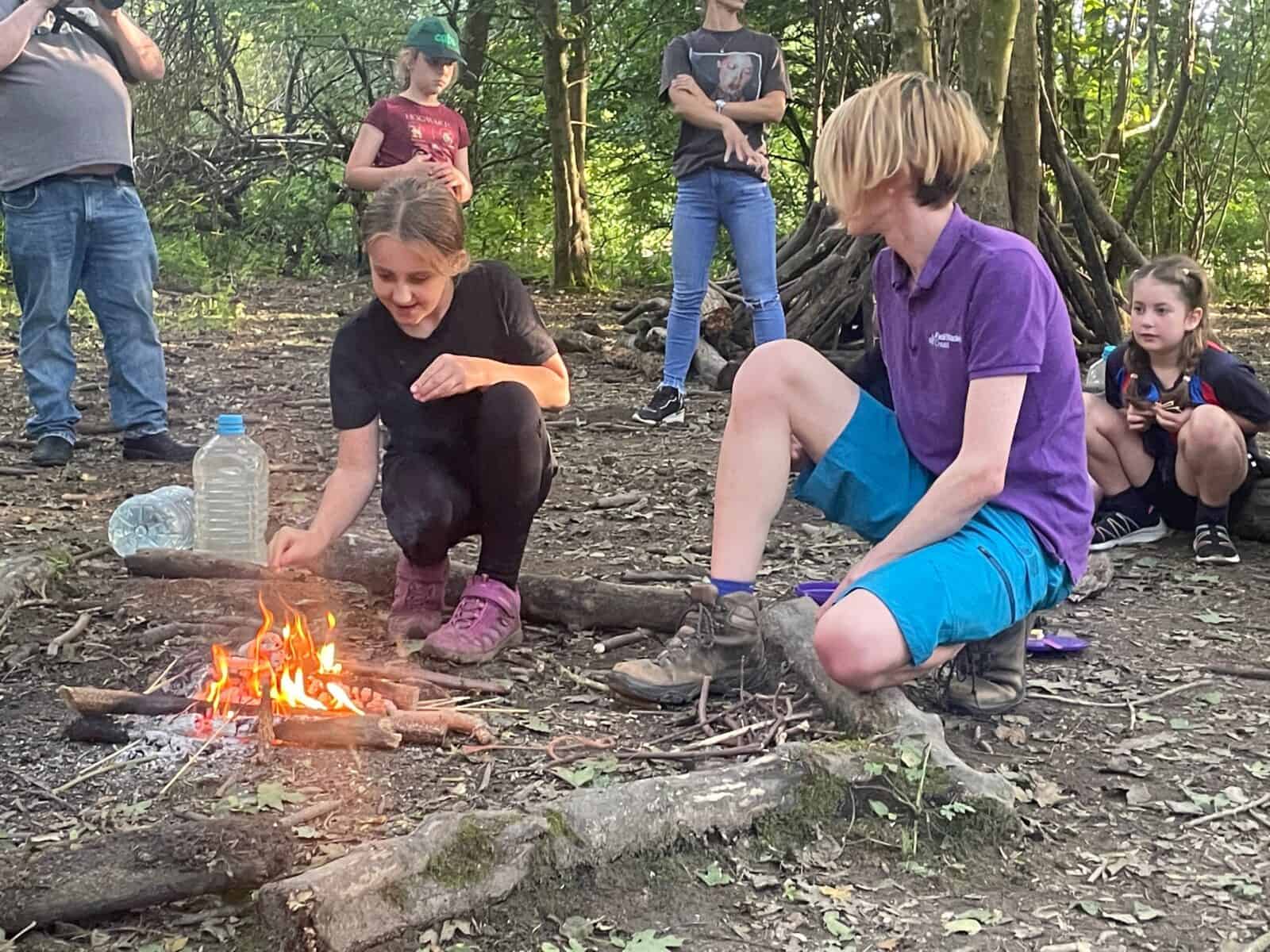 children being supervised to toast marshmallows