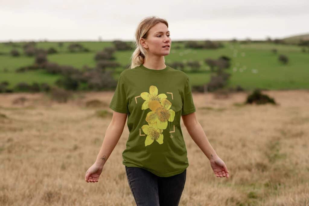 Women wearing a green t-shirt with marsh marigolds on it