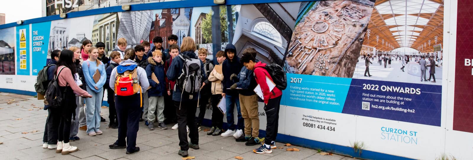 group of students in front of graffiti wall