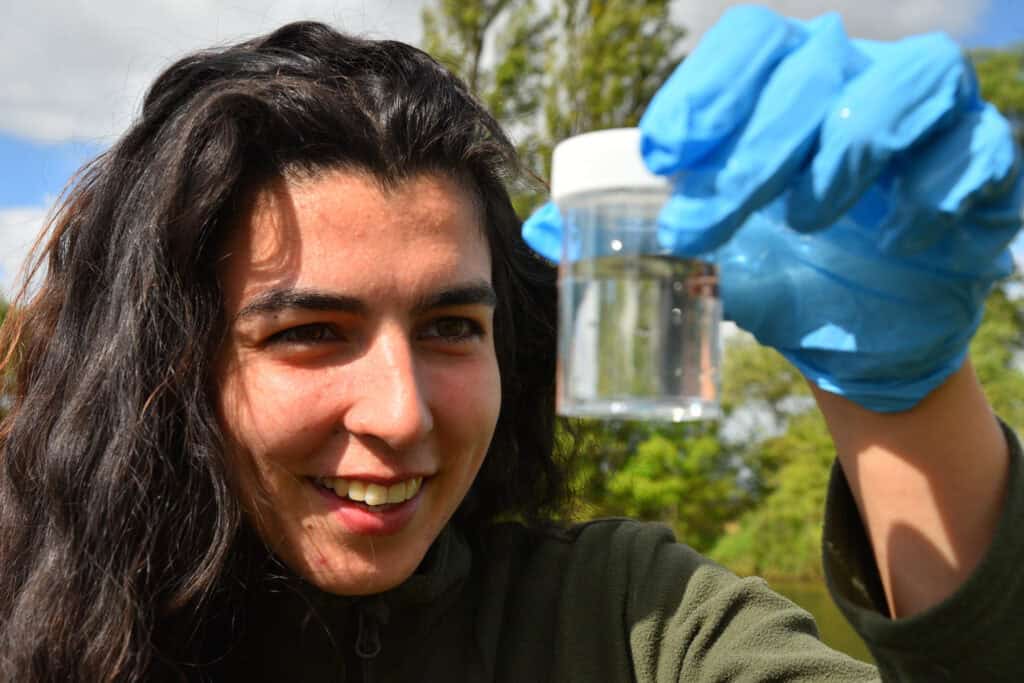 girl smiling looking at insect