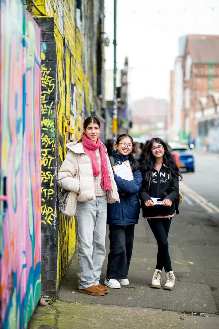 students by graffiti wall in Digbeth