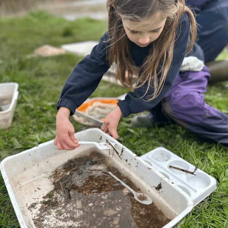 Girl looking at pond water