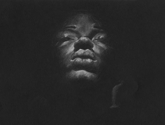 A drawing of a women's face on a black background