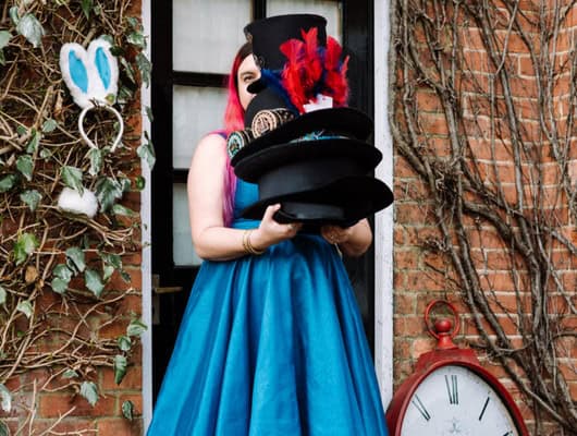 A photograph of someone holding the mad hatter's hat.