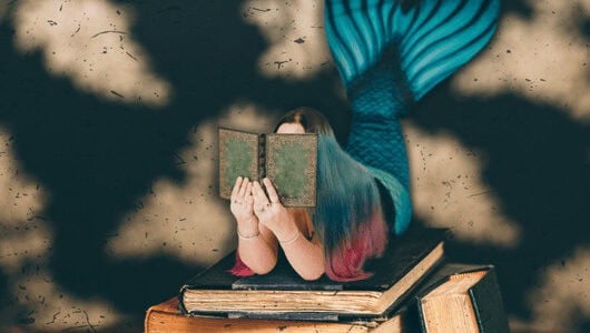 A photo of a mermaid on a pile of books - Fantasy photography