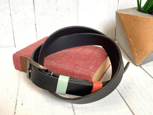 A dark brown leather belt on a book