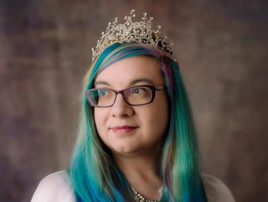 A photograph of a women with a crown on