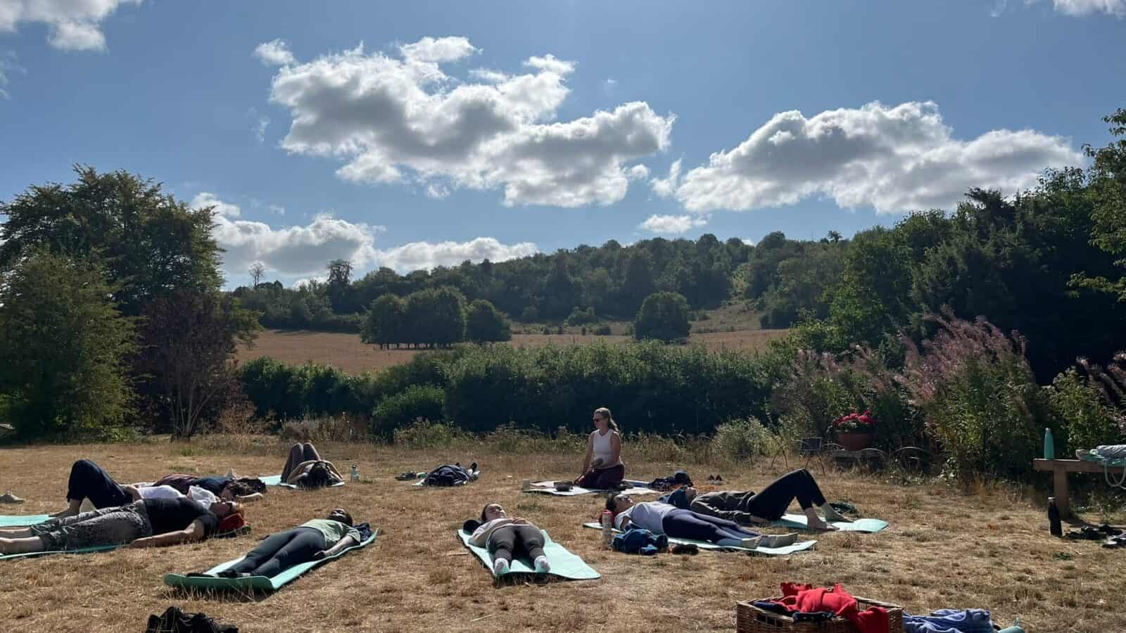 A photo of a group doing outdoor yoga - Wellbeing in Nature Weekend
