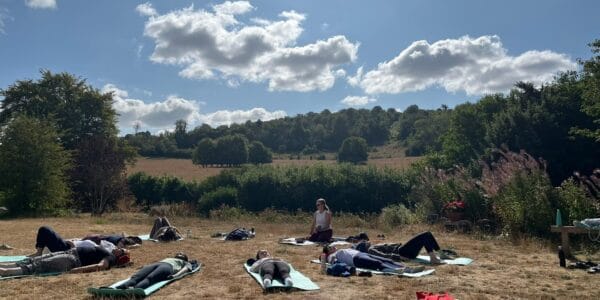 A photo of a group doing outdoor yoga - Wellbeing in Nature Weekend