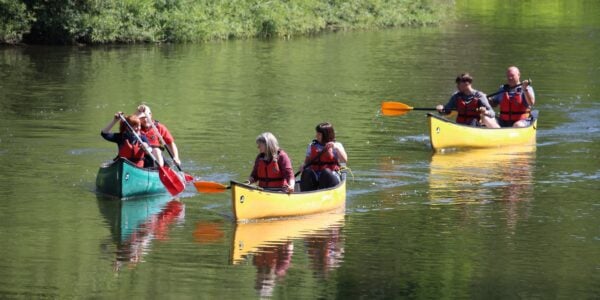 group of adults canoeing