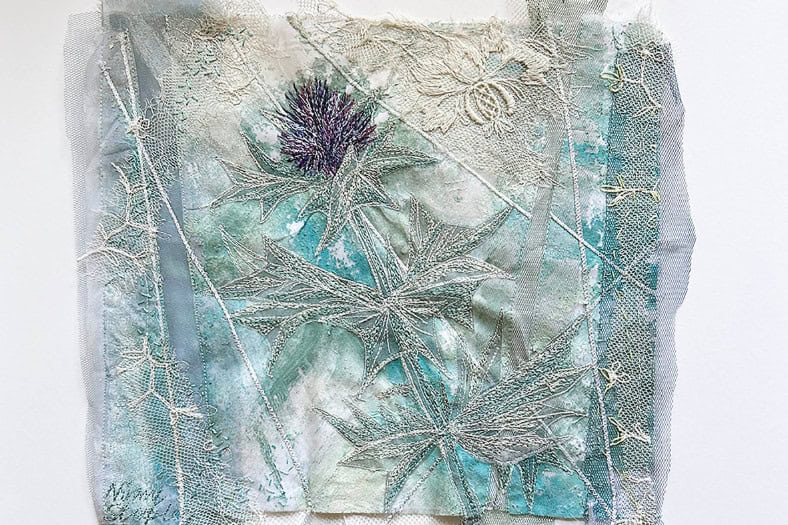 A photo of an embroidery of blue and silver threads - Flatford sketch and stitch,